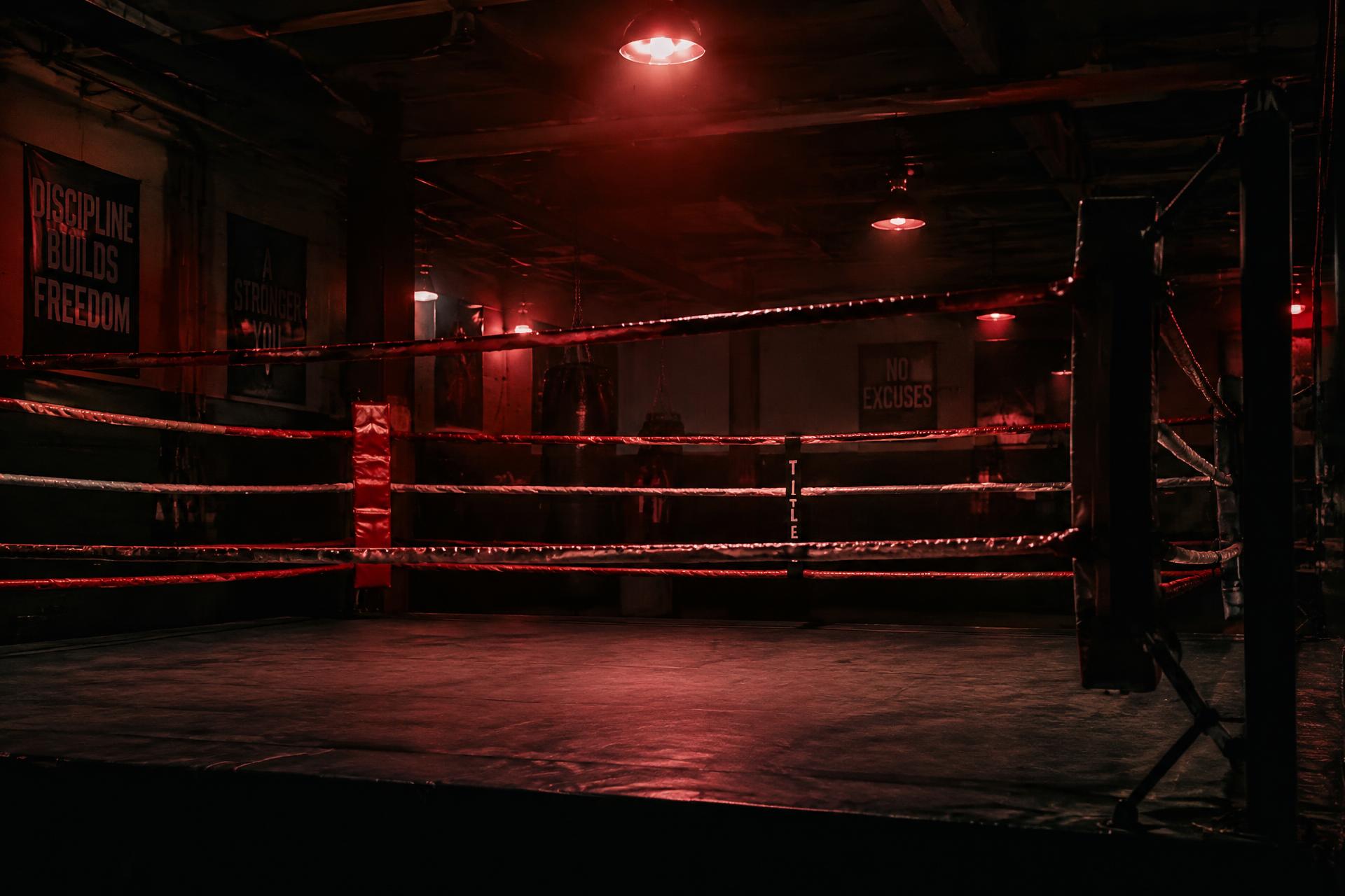 Empty boxing ring lit in red